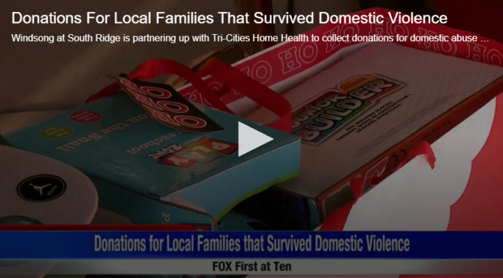 pile of presents with text on screen reading "donations for local families that survived domestic violence"
