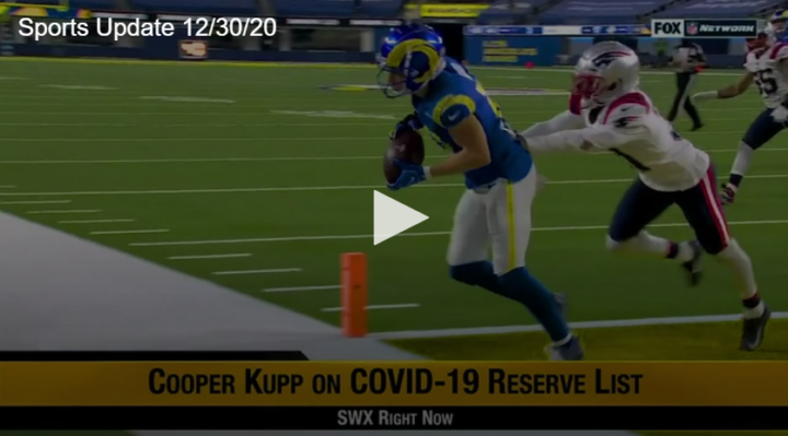 football player with football running across touchdown line