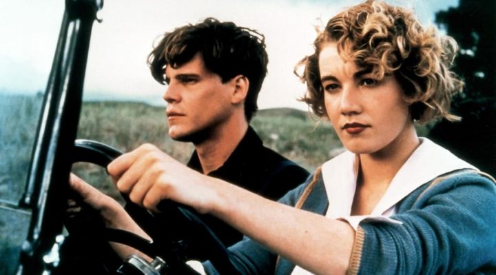scene from a river runs through it with craig sheffer (norman) sitting in the passenger seat and emily lloyd (jessie) driving a 1920s car