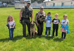 FCSO & ACSO share information with a K-9 unit about D.A.R.E. to students