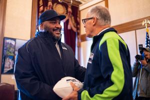 Walter Jones joins Gov. Jay Inslee to raise Seahawks flag at the Capitol